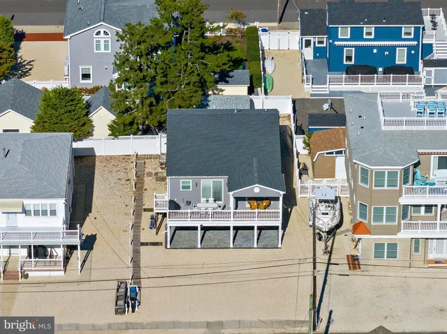 an aerial view of residential houses with outdoor space and parking