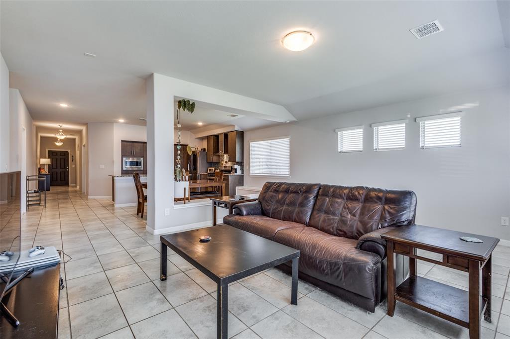 1404 Rosebush Road Aubrey, TX 76227 - Photo 13 of 25 a living room with furniture and a dining table with kitchen view