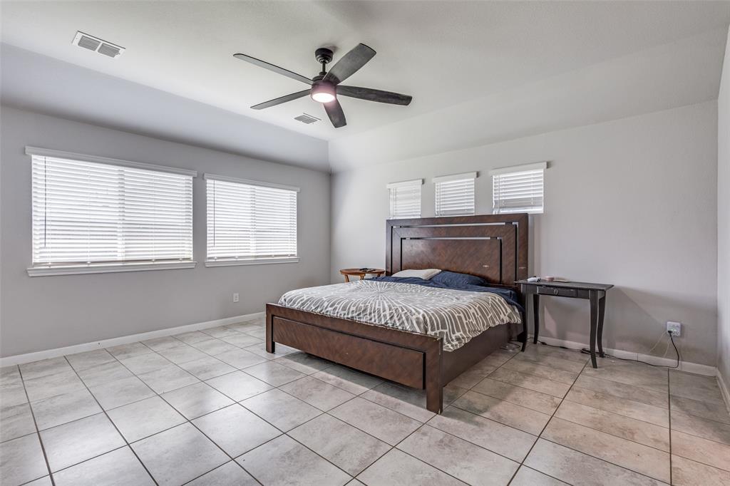 1404 Rosebush Road Aubrey, TX 76227 - Photo 14 of 25 a bedroom with a bed and window