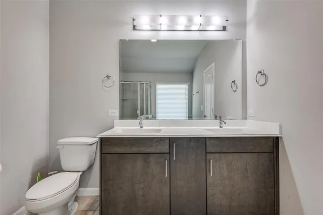 a bathroom with a toilet a sink and a mirror