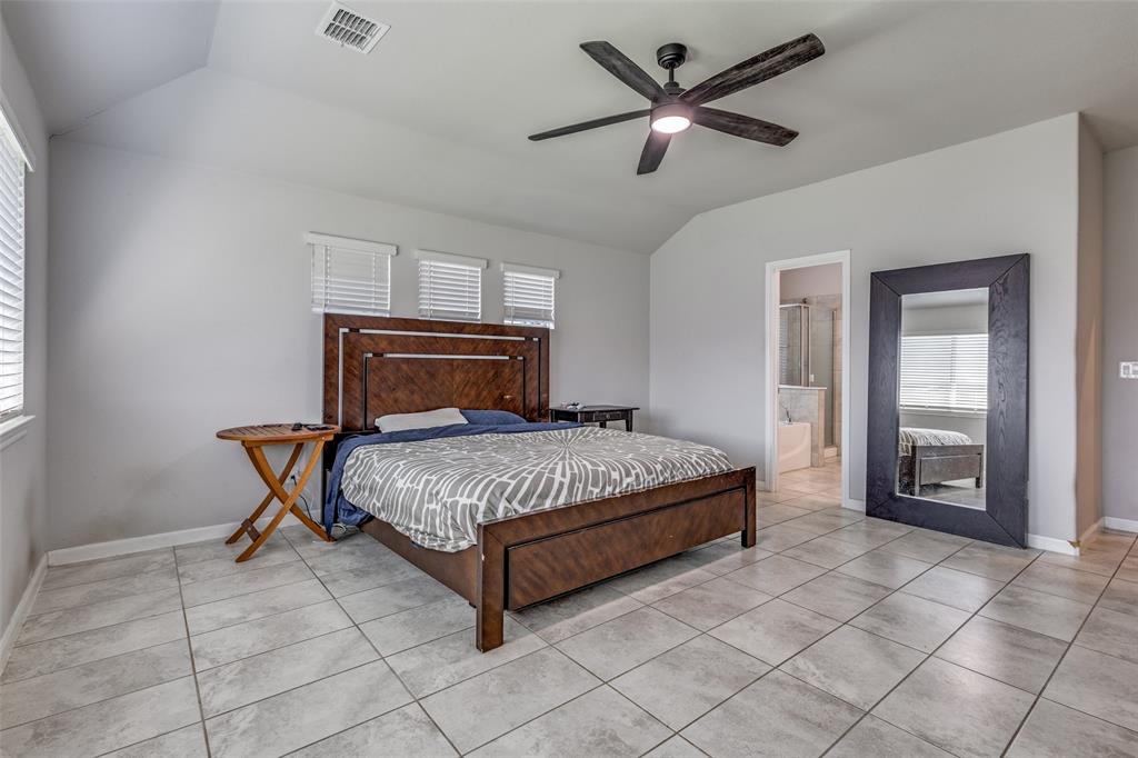 1404 Rosebush Road Aubrey, TX 76227 - Photo 15 of 25 a bedroom with a bed and a chandelier