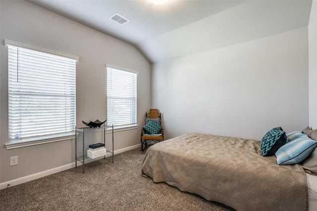 a bedroom with a bed and windows