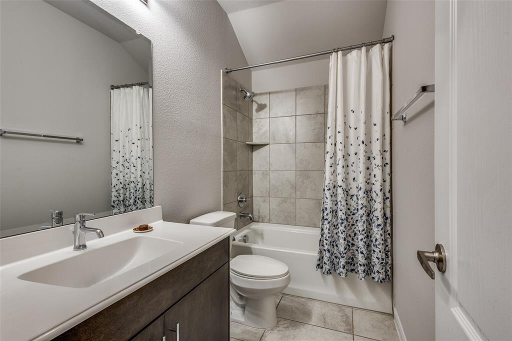 1404 Rosebush Road Aubrey, TX 76227 - Photo 21 of 25 a bathroom with a sink a toilet and shower