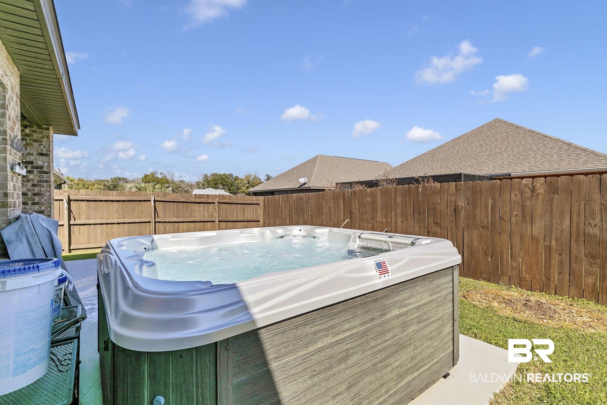 1547 Kairos Loop Foley, AL 36535 - Photo 45 of 55 View of fenced backyard with extended patio and a hot tub