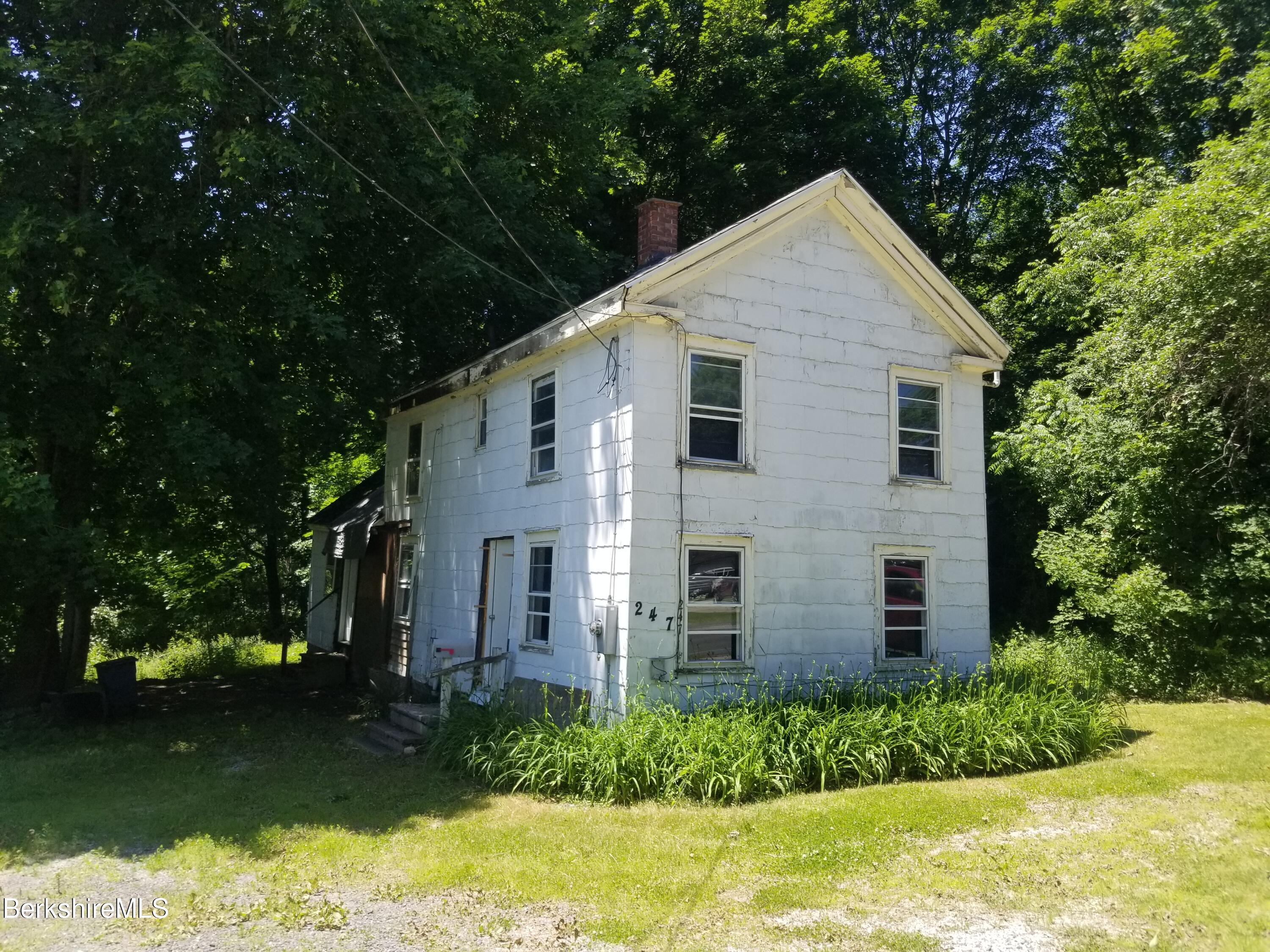 247 Pecks Road Pittsfield, MA 01201 - Photo 1 of 13 a view of a house with backyard and garden