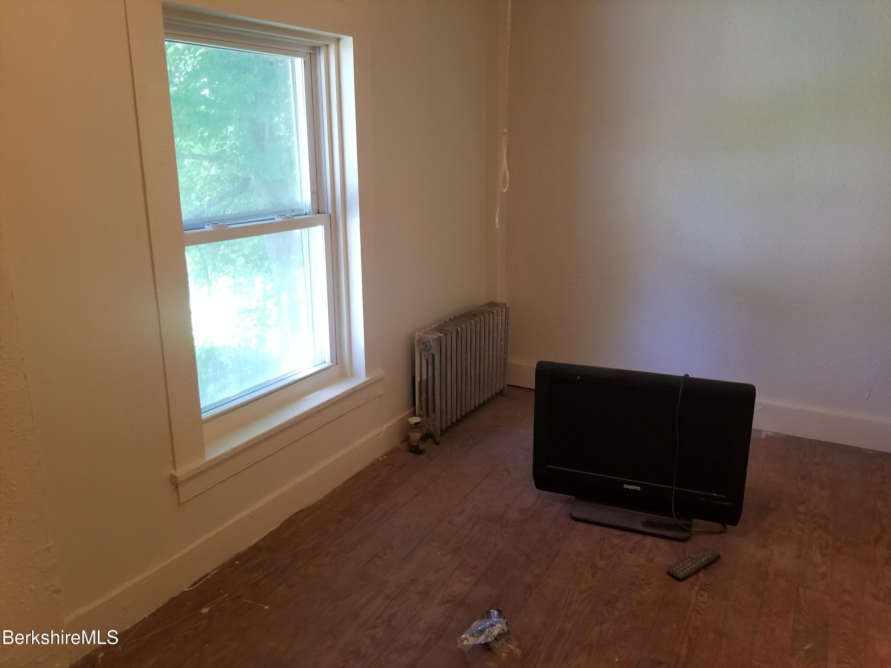 247 Pecks Road Pittsfield, MA 01201 - Photo 8 of 13 a room with a window and a ceiling fan
