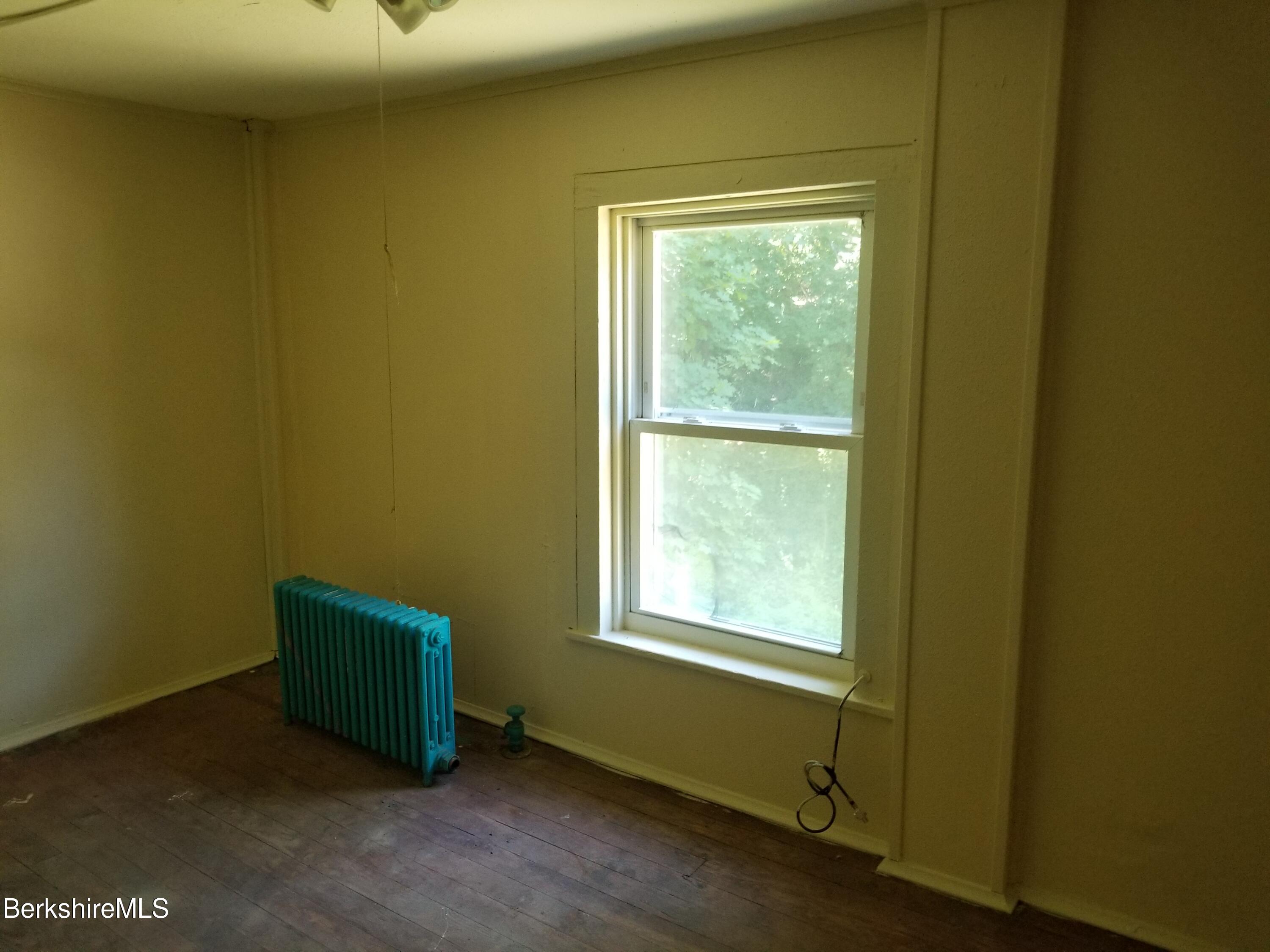 247 Pecks Road Pittsfield, MA 01201 - Photo 10 of 13 a room with a window and a wooden floor