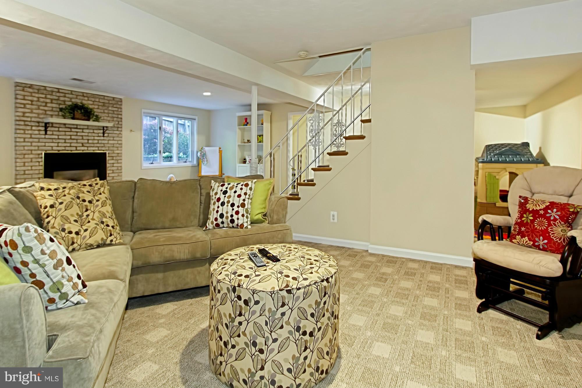 3900 Chesterbrook Road Arlington, VA 22207 - Photo 22 of 30 a living room with furniture and a fireplace