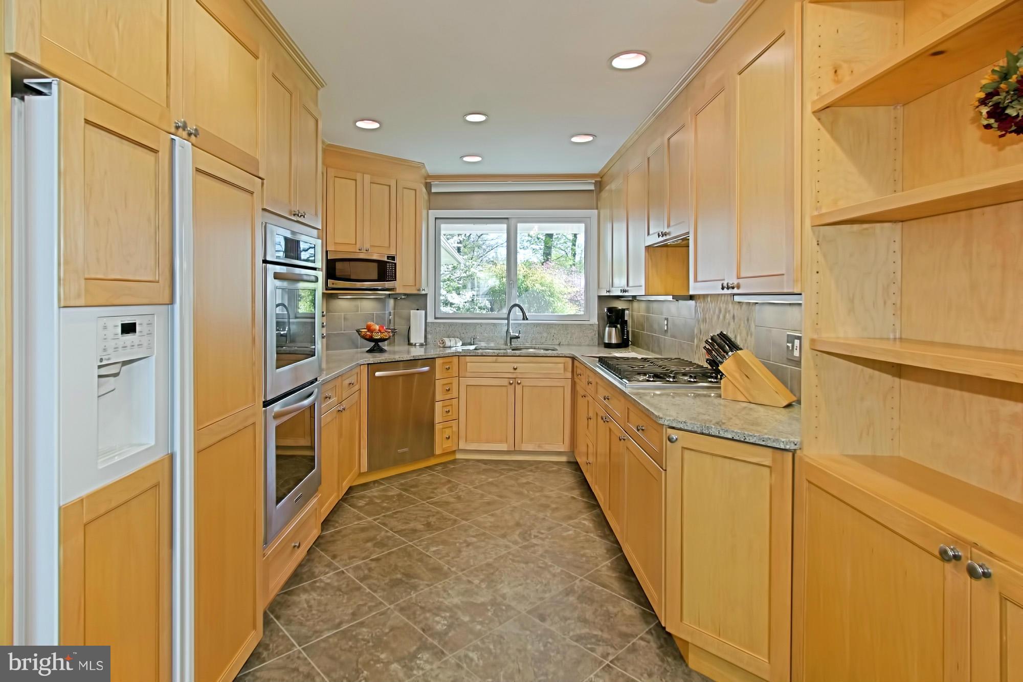 3900 Chesterbrook Road Arlington, VA 22207 - Photo 8 of 30 a kitchen with stainless steel appliances granite countertop a sink a stove a refrigerator cabinets and a refrigerator