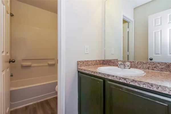 a bathroom with a granite countertop sink and a mirror