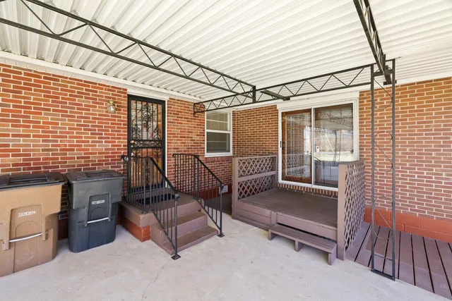 a view of a patio with couches chairs and wooden floor