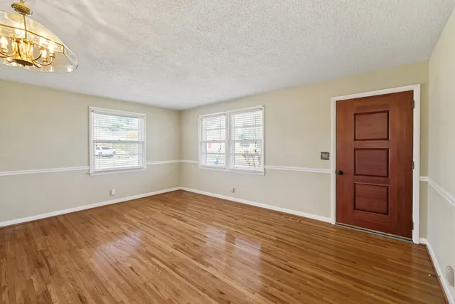 an empty room with windows and closet