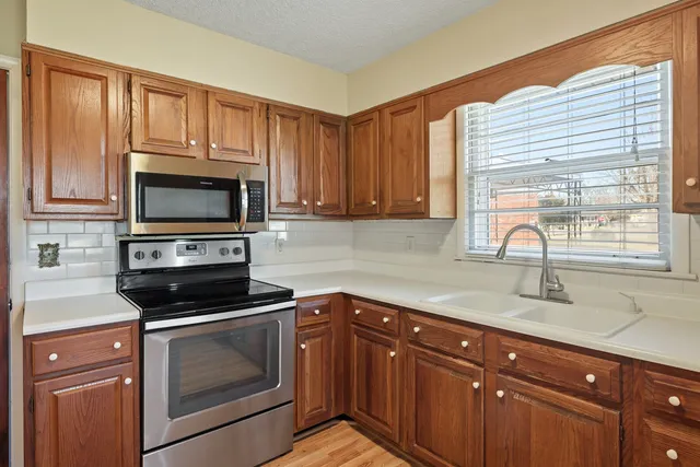 a kitchen with a sink stove and microwave
