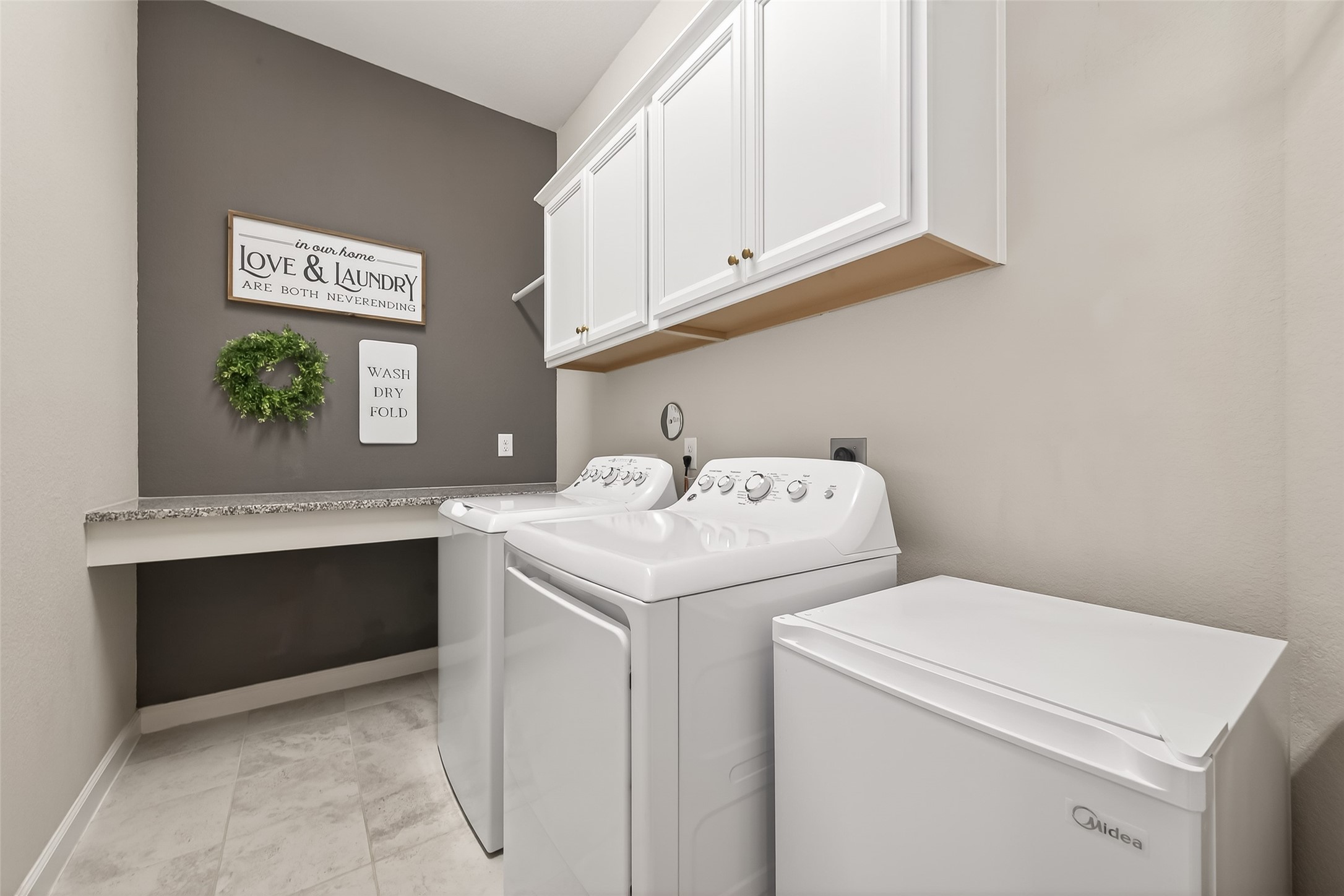 1307 Layla Sage Loop Richmond, TX 77406 - Photo 29 of 50 Large laundry room with built-in cabinets and granite folding station (appliances excluded)