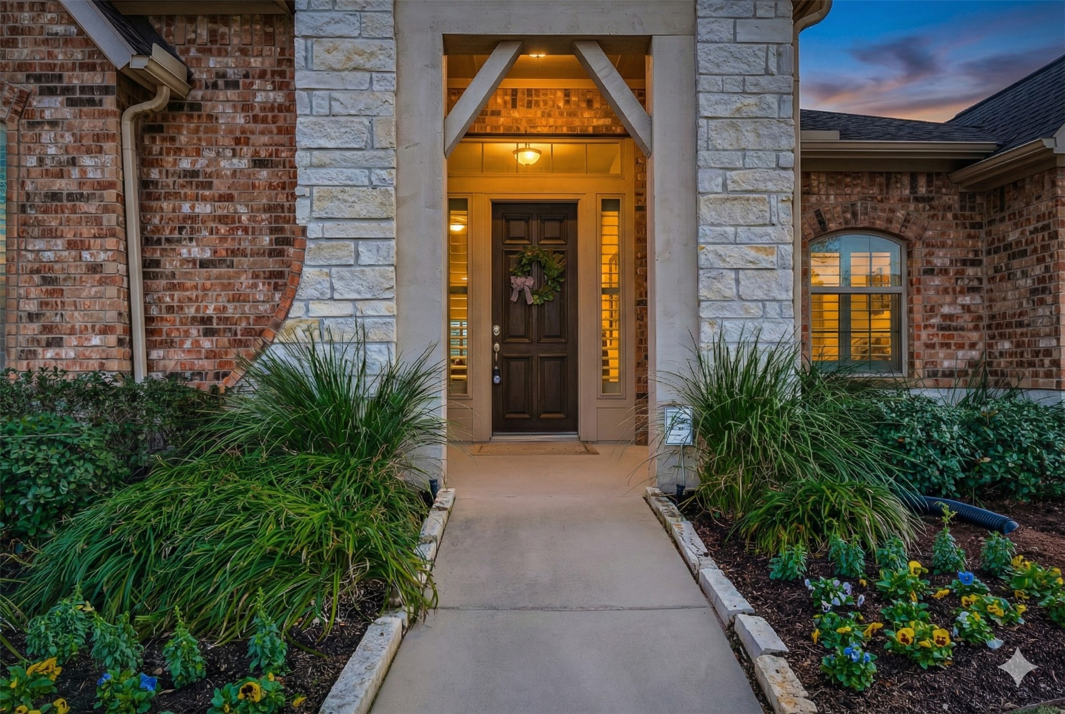 1307 Layla Sage Loop Richmond, TX 77406 - Photo 5 of 50 From the moment you arrive, you’ll be captivated by the home’s striking brick and stone exterior, lush landscaping, and an inviting covered front porch anchored by a grand 8-foot solid wood entry door.