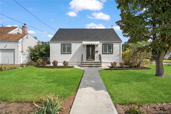 a front view of house with yard and green space
