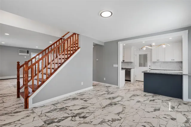 a view of a kitchen with wooden floor and staircase