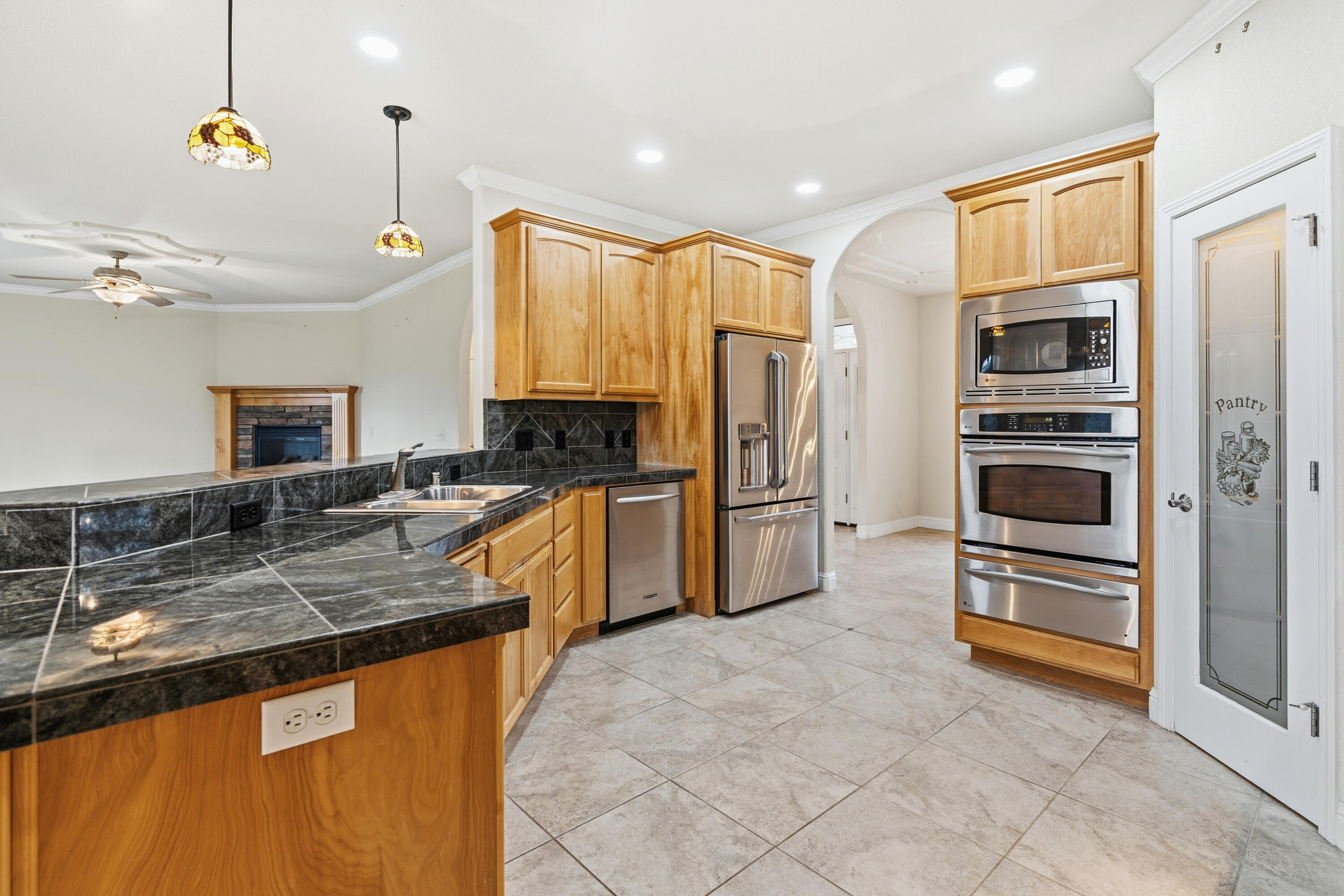 14535 Molluc Drive Red Bluff, CA 96080 - Photo 10 of 72 a kitchen with granite countertop a refrigerator a sink a stove and cabinets