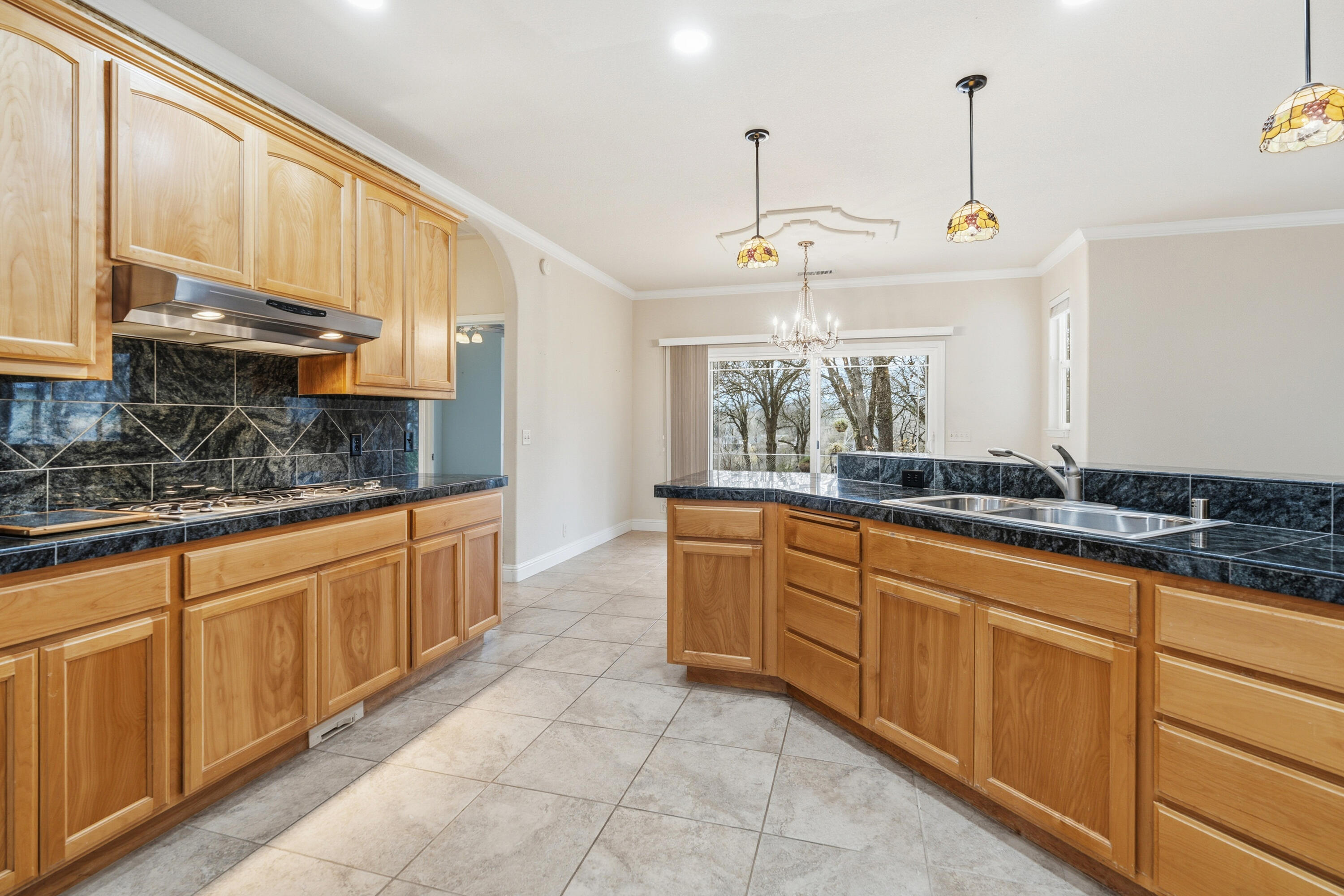 14535 Molluc Drive Red Bluff, CA 96080 - Photo 11 of 72 a large kitchen with kitchen island granite countertop a sink a counter top space and cabinets