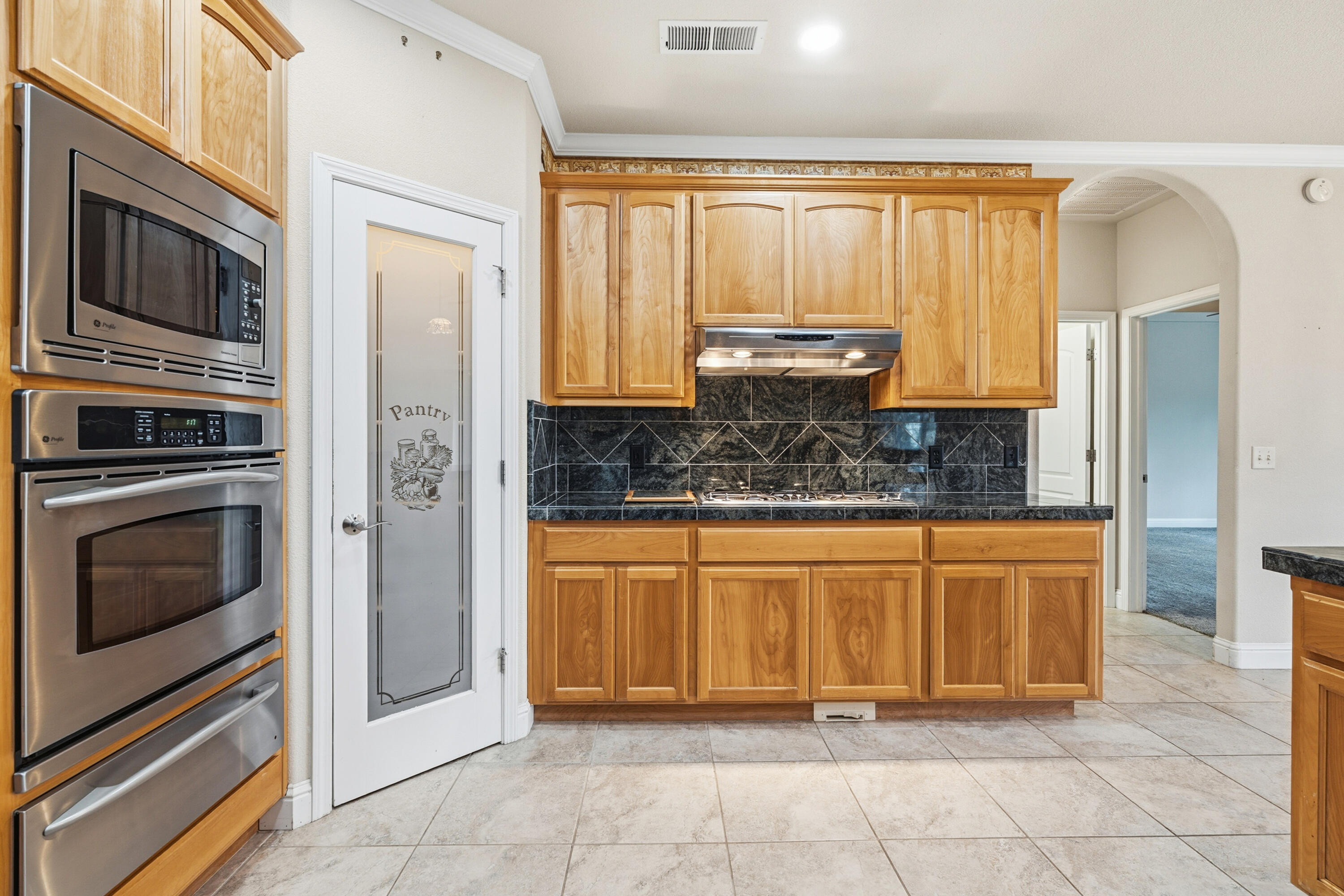 14535 Molluc Drive Red Bluff, CA 96080 - Photo 13 of 72 a kitchen with stainless steel appliances granite countertop a stove a sink and a microwave