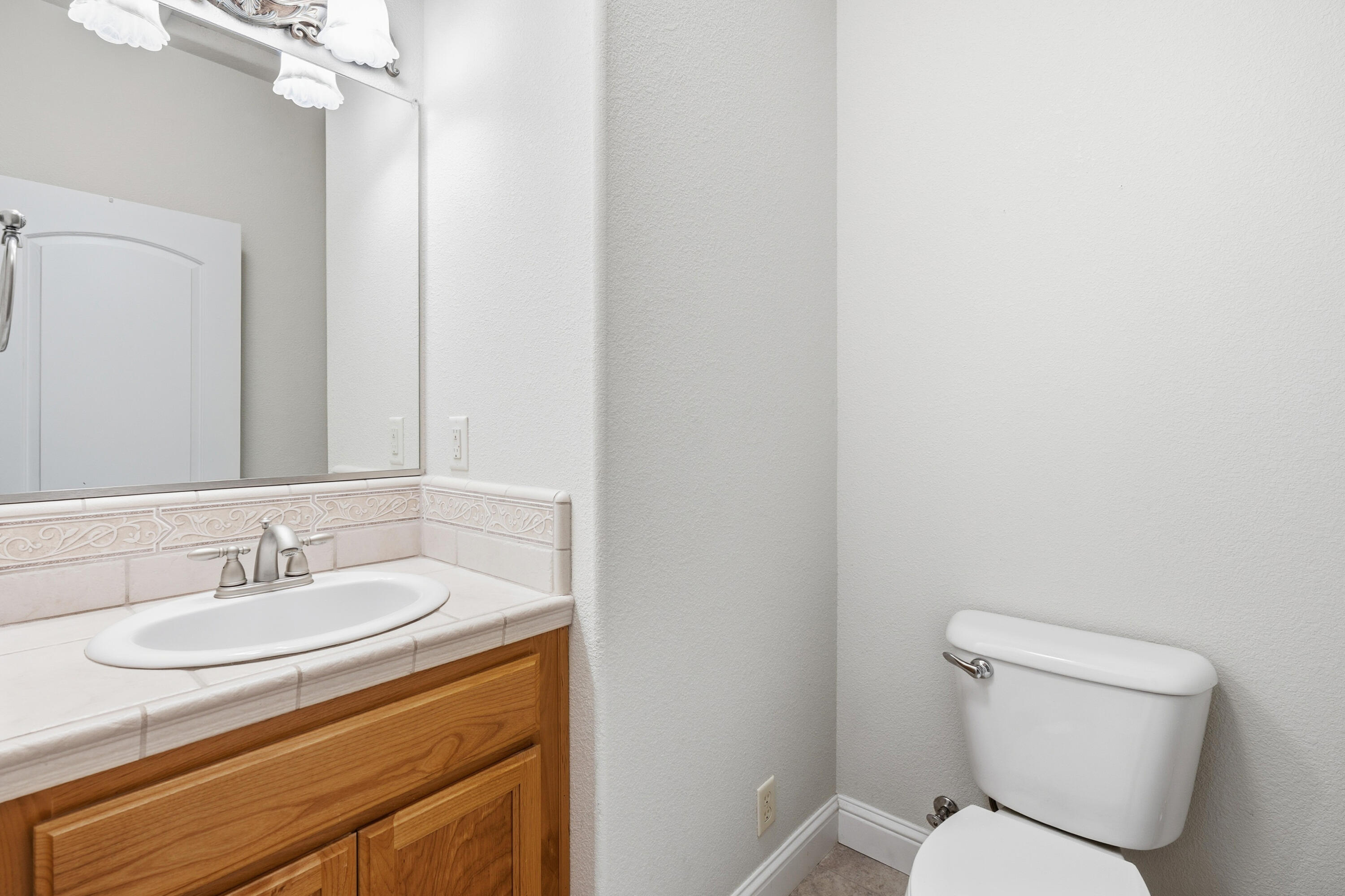 14535 Molluc Drive Red Bluff, CA 96080 - Photo 17 of 72 a bathroom with a sink toilet and a mirror