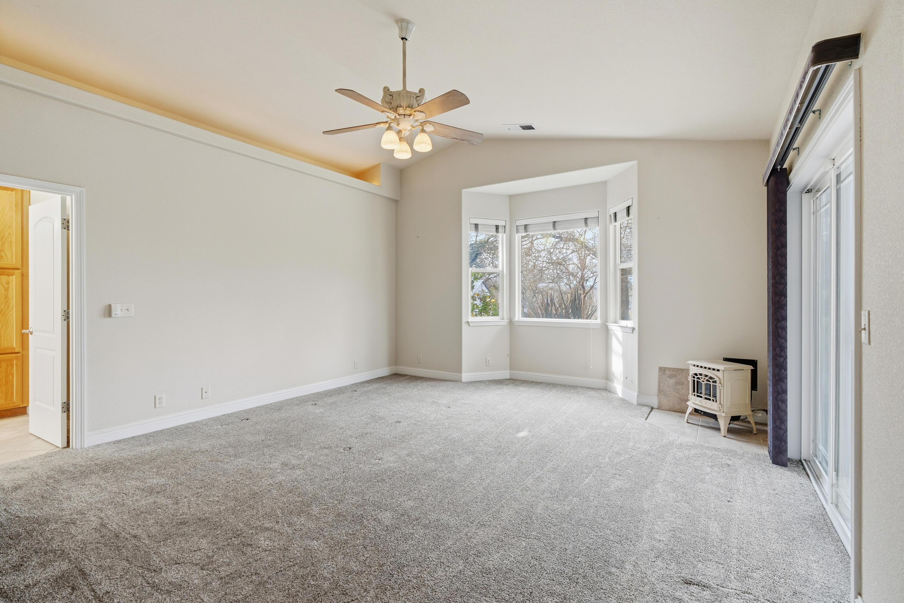 14535 Molluc Drive Red Bluff, CA 96080 - Photo 18 of 72 an empty room with chandelier fan and windows