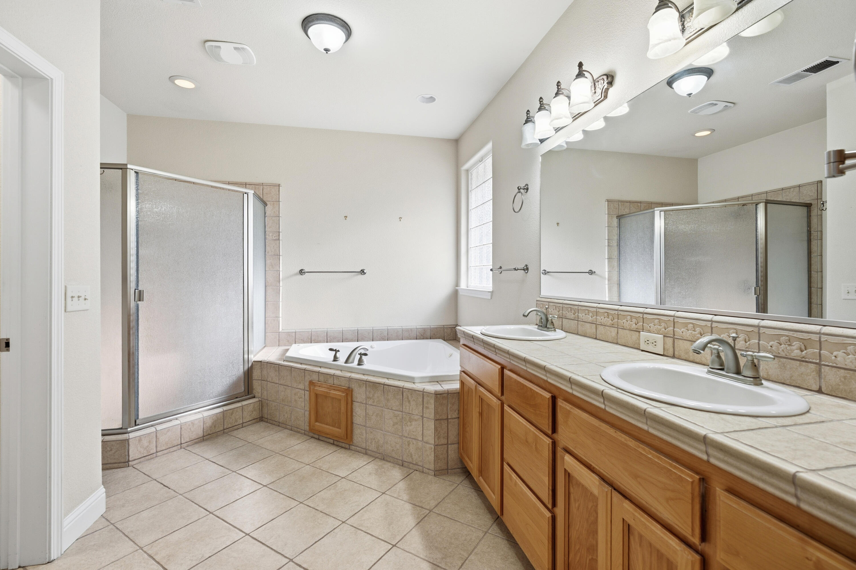 14535 Molluc Drive Red Bluff, CA 96080 - Photo 21 of 72 a spacious bathroom with a sink double vanity granite and a mirror