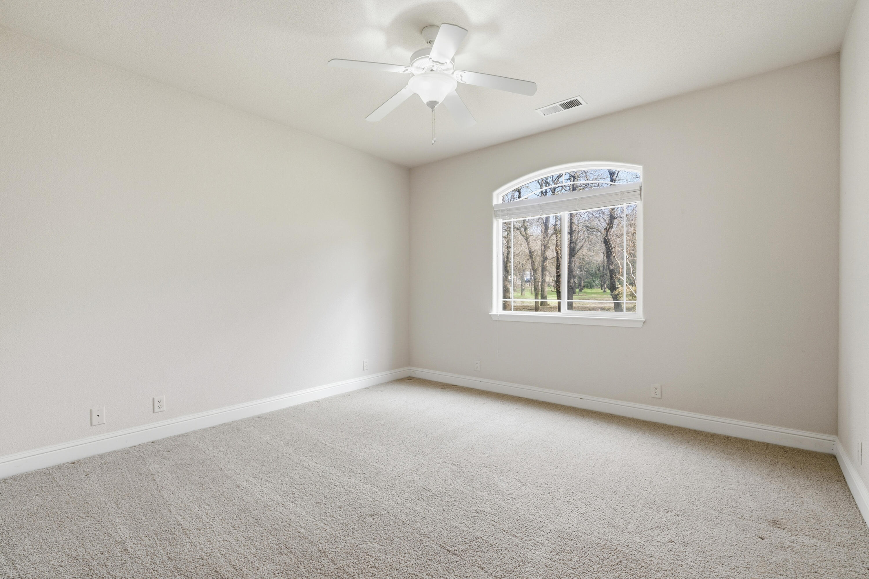 14535 Molluc Drive Red Bluff, CA 96080 - Photo 33 of 72 an empty room with windows and fan