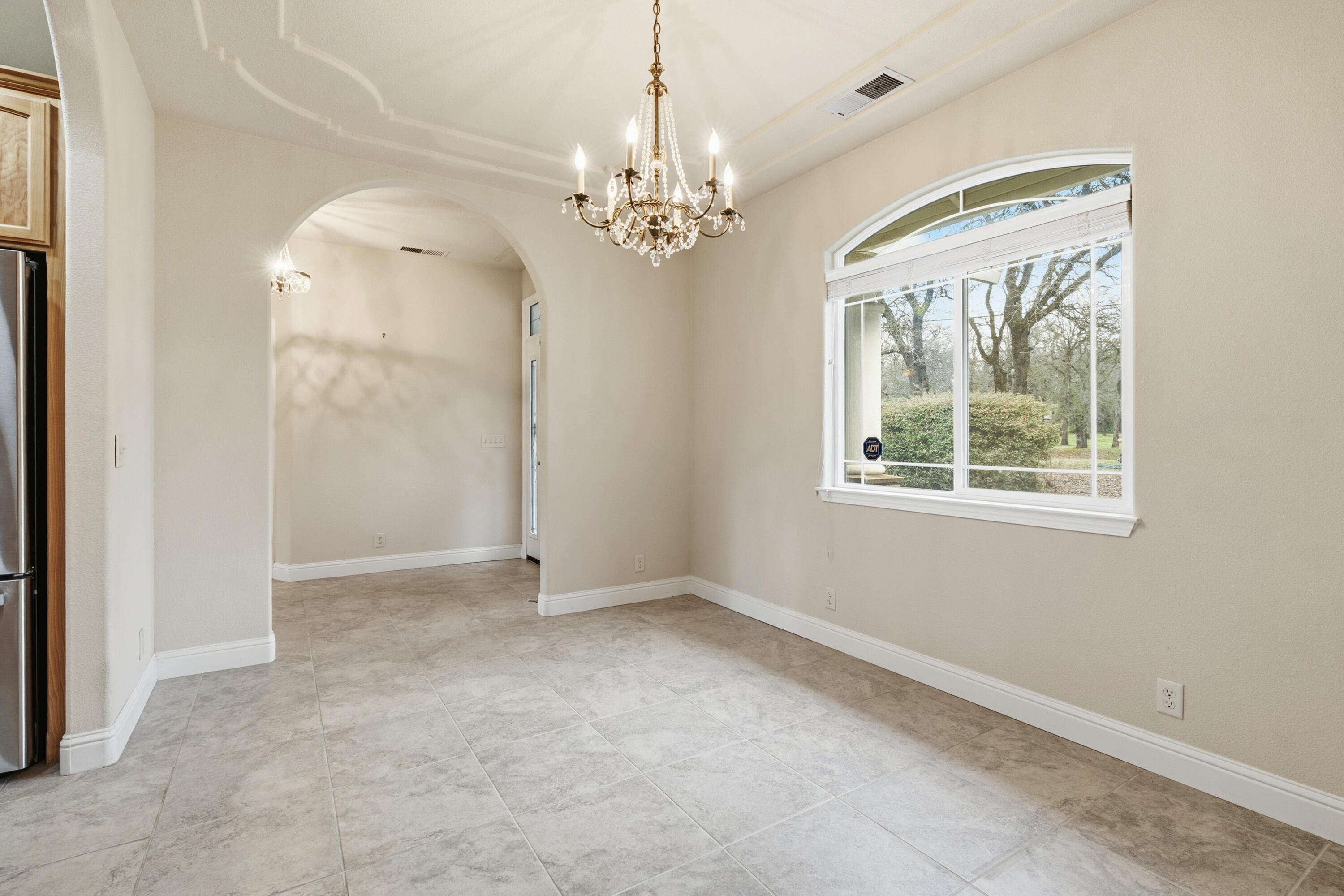 14535 Molluc Drive Red Bluff, CA 96080 - Photo 3 of 72 en empty room with windows and chandelier
