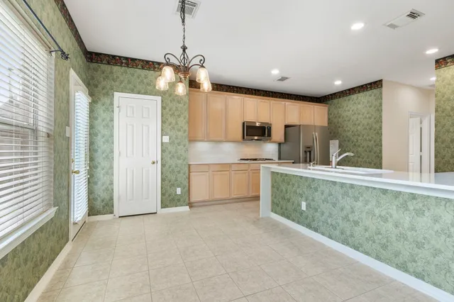 a view of a kitchen with a sink and dishwasher a refrigerator with wooden floor