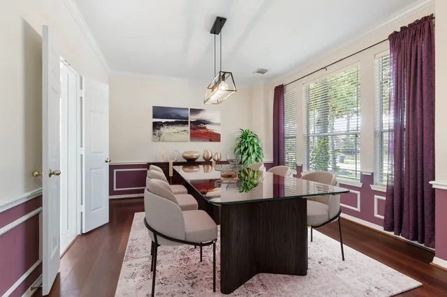 a dining room with furniture window and wooden floor