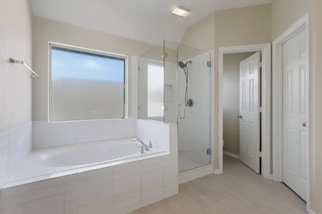 a bathroom with a bathtub and a shower