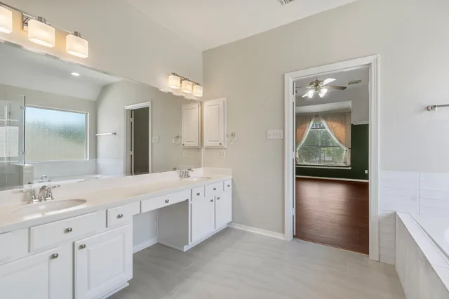 a bathroom with a double vanity sink and mirror