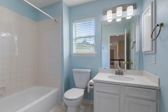 a bathroom with a toilet a sink and a bathtub
