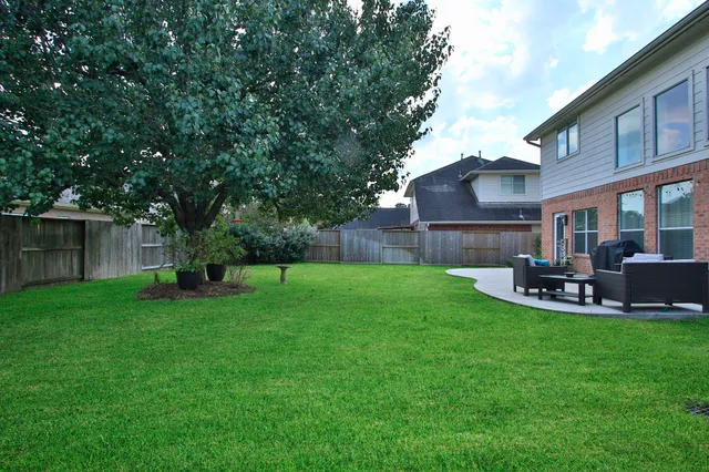 a view of a house with a yard and sitting area
