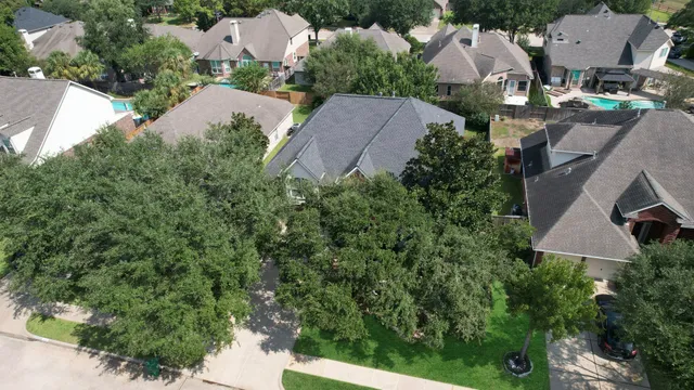 an aerial view of multiple houses with yard