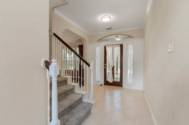 a view of entryway and hall with a front door