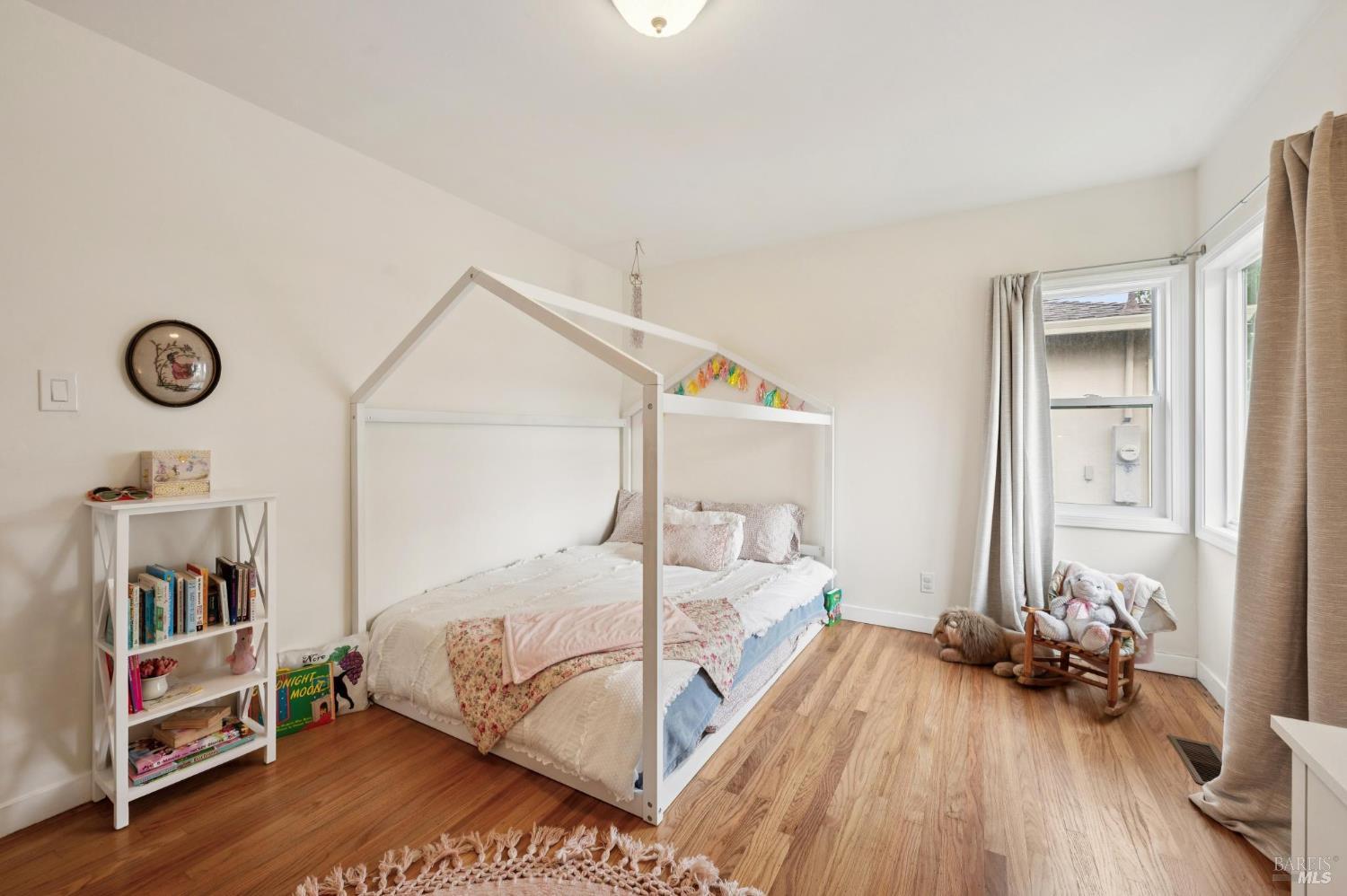 105 Corrillo Drive San Rafael, CA 94903 - Photo 19 of 33 a bedroom with bed and a wooden floor