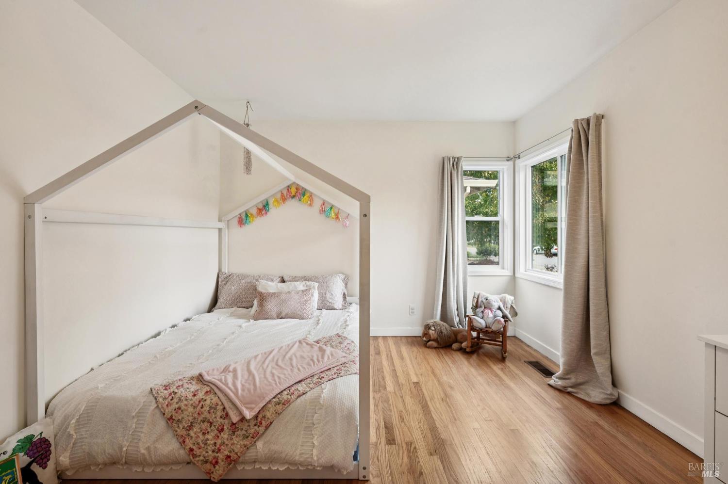 105 Corrillo Drive San Rafael, CA 94903 - Photo 20 of 33 a bedroom with a bed and wooden floor