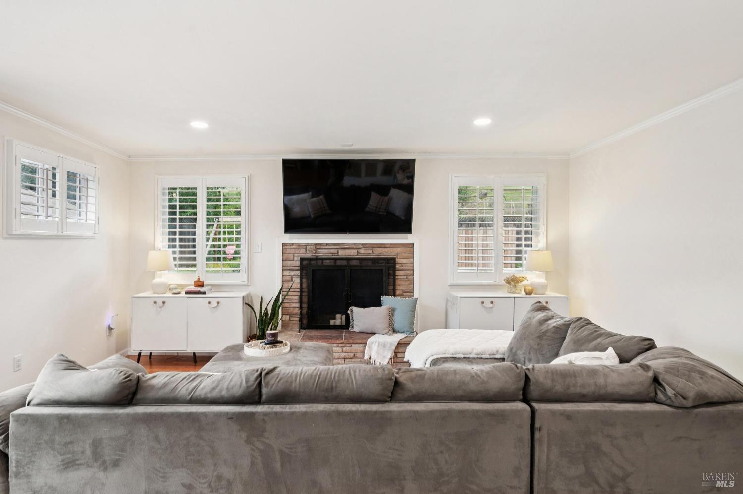 105 Corrillo Drive San Rafael, CA 94903 - Photo 8 of 33 a living room with furniture a flat screen tv and a fireplace