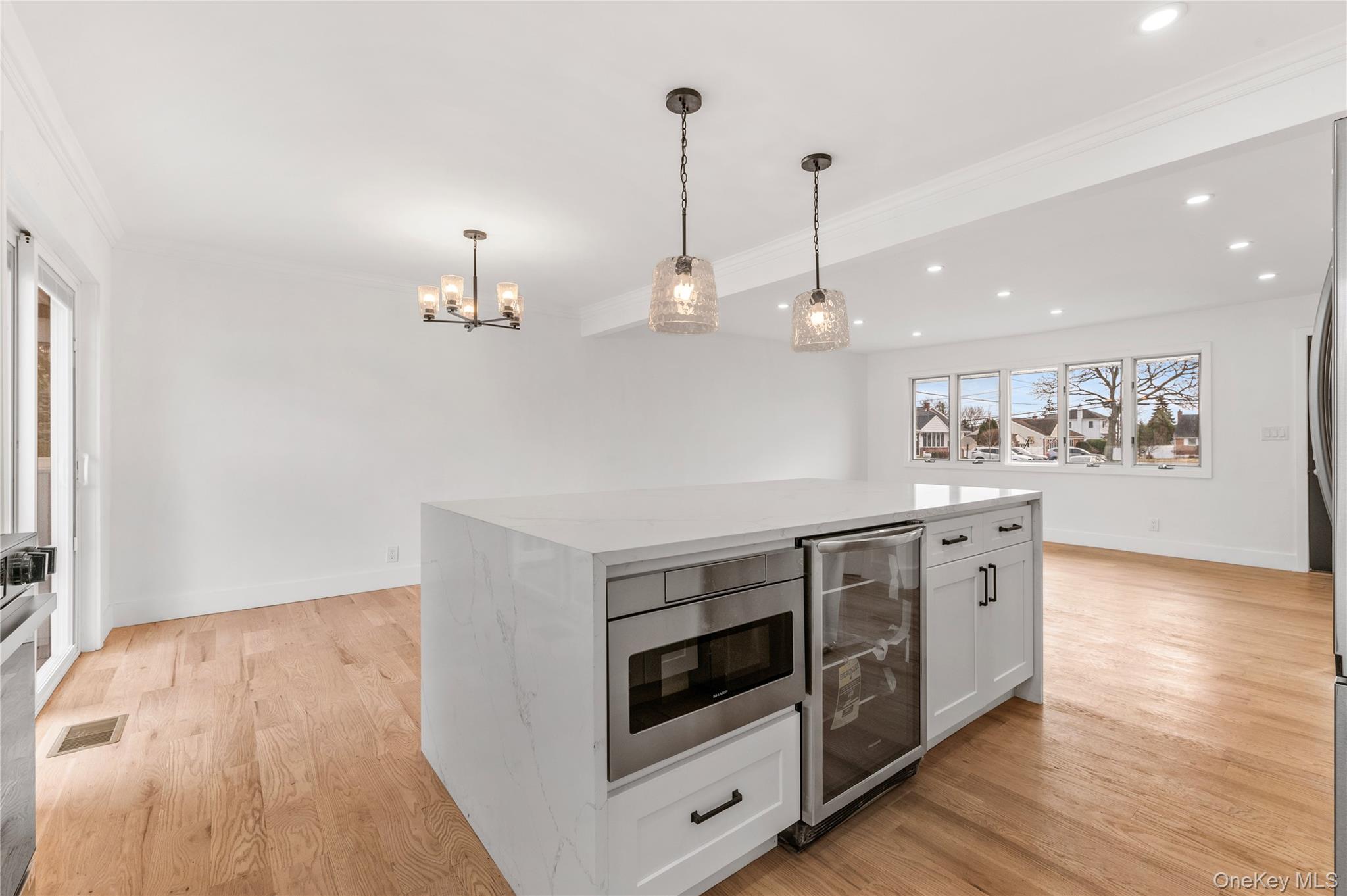 19 Hicks Avenue Syosset, NY 11791 - Photo 11 of 30 a kitchen with stainless steel appliances granite countertop a stove a sink and a wooden floor