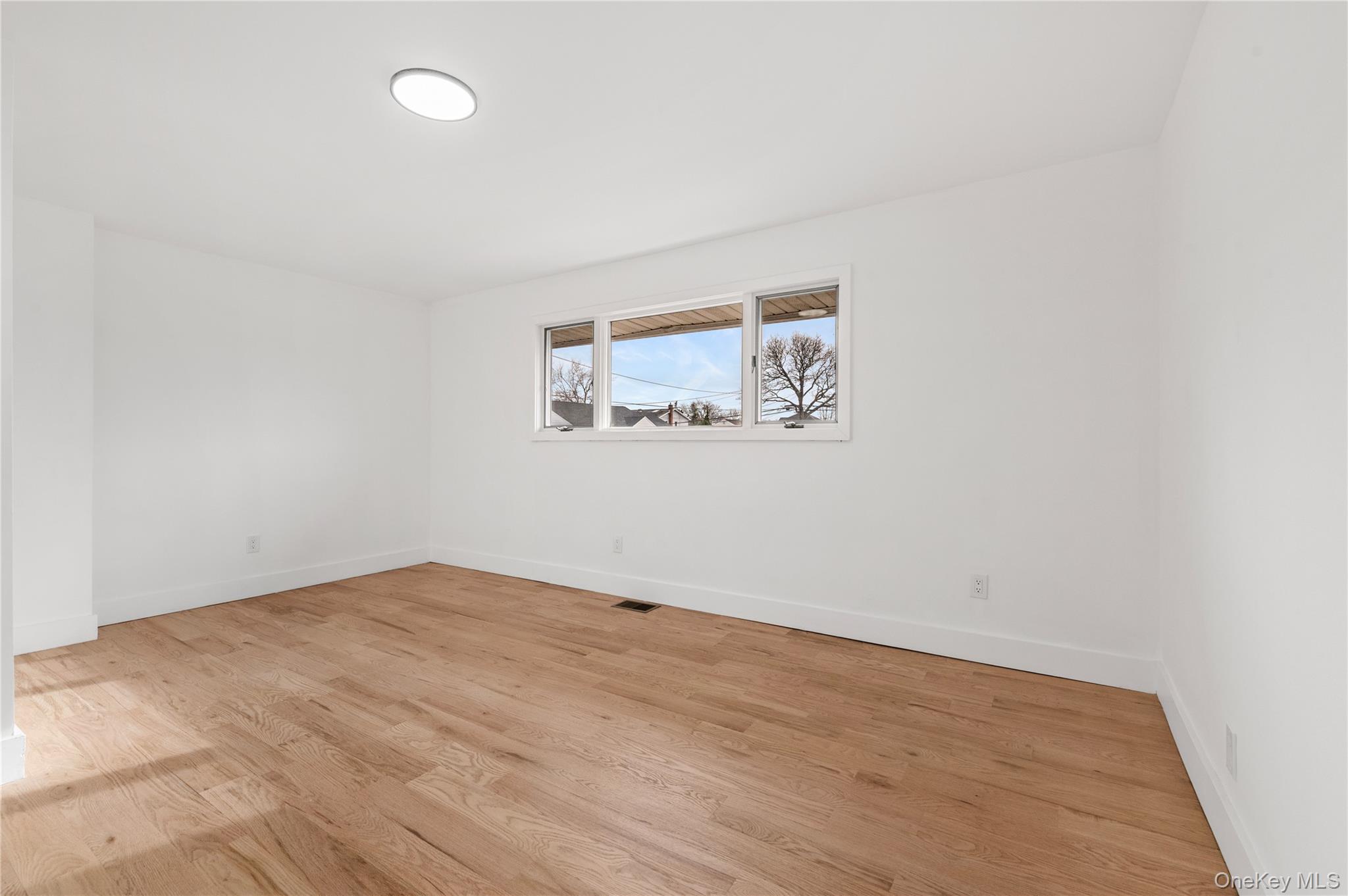 19 Hicks Avenue Syosset, NY 11791 - Photo 14 of 30 an empty room with a painting on the wall