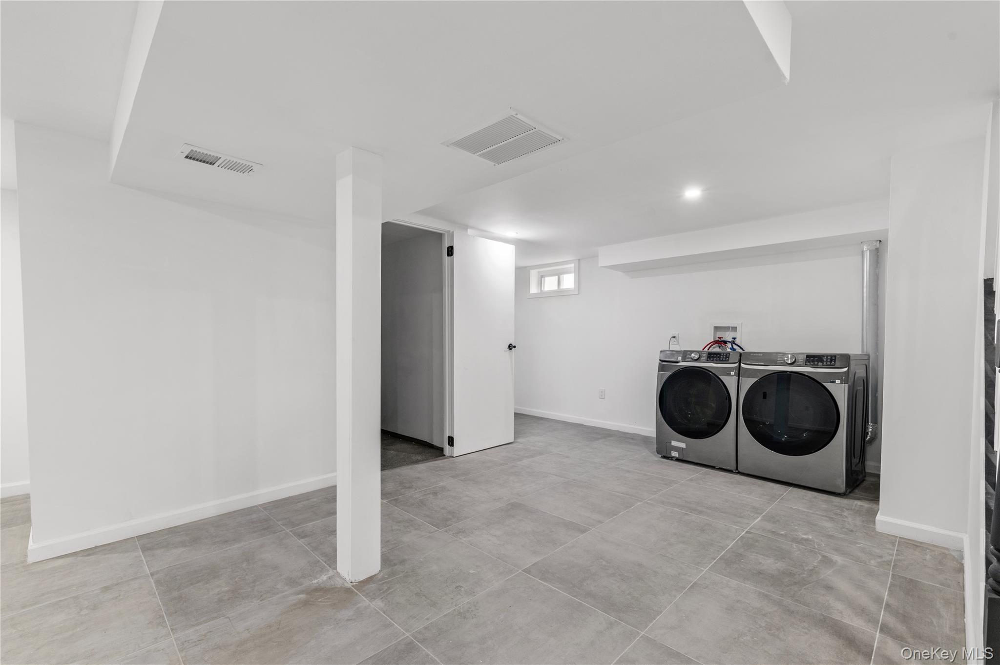 19 Hicks Avenue Syosset, NY 11791 - Photo 24 of 30 a view of a storage and utility room with a washer and dryer