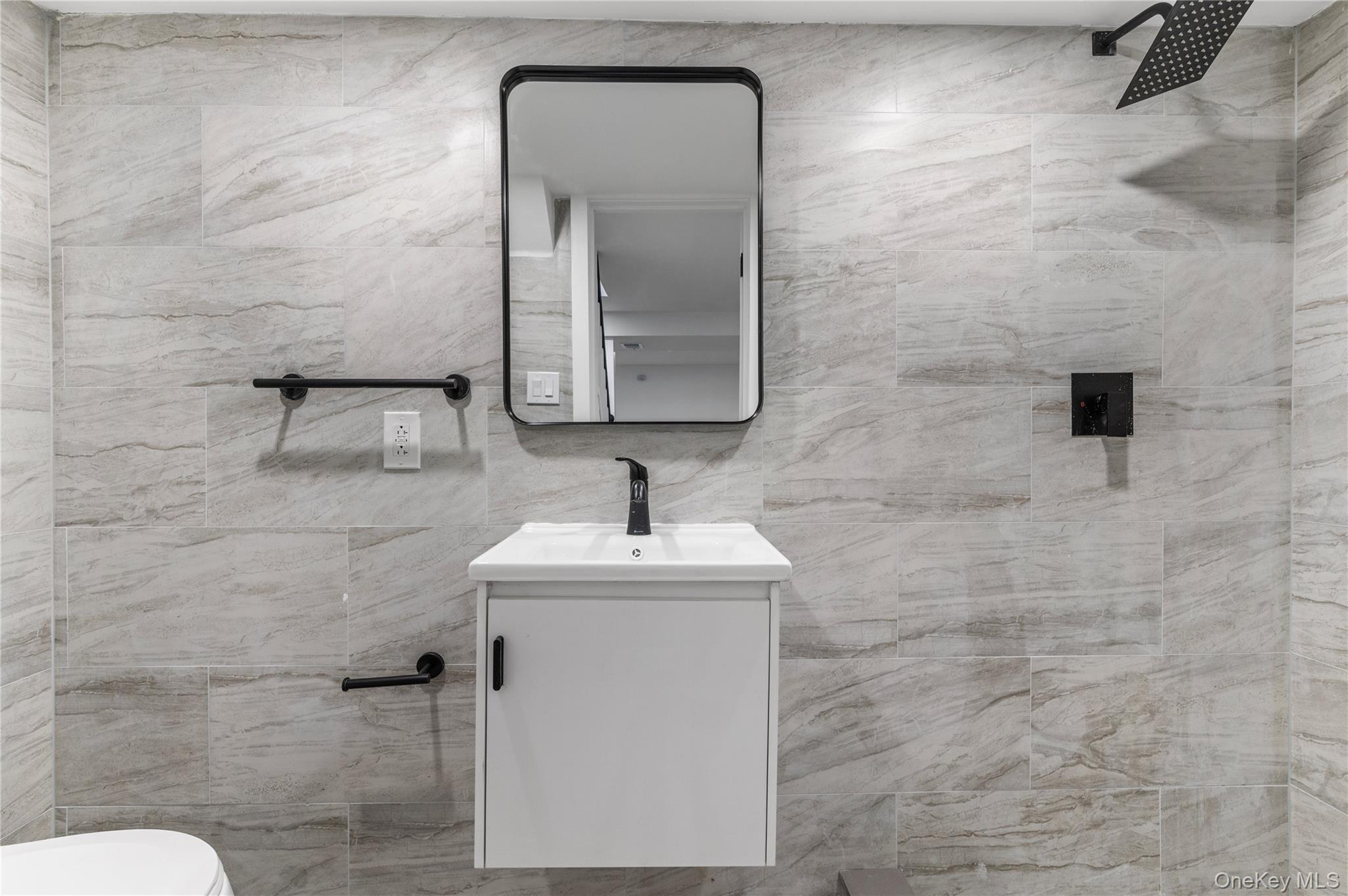 19 Hicks Avenue Syosset, NY 11791 - Photo 26 of 30 a bathroom with a sink a toilet and mirror