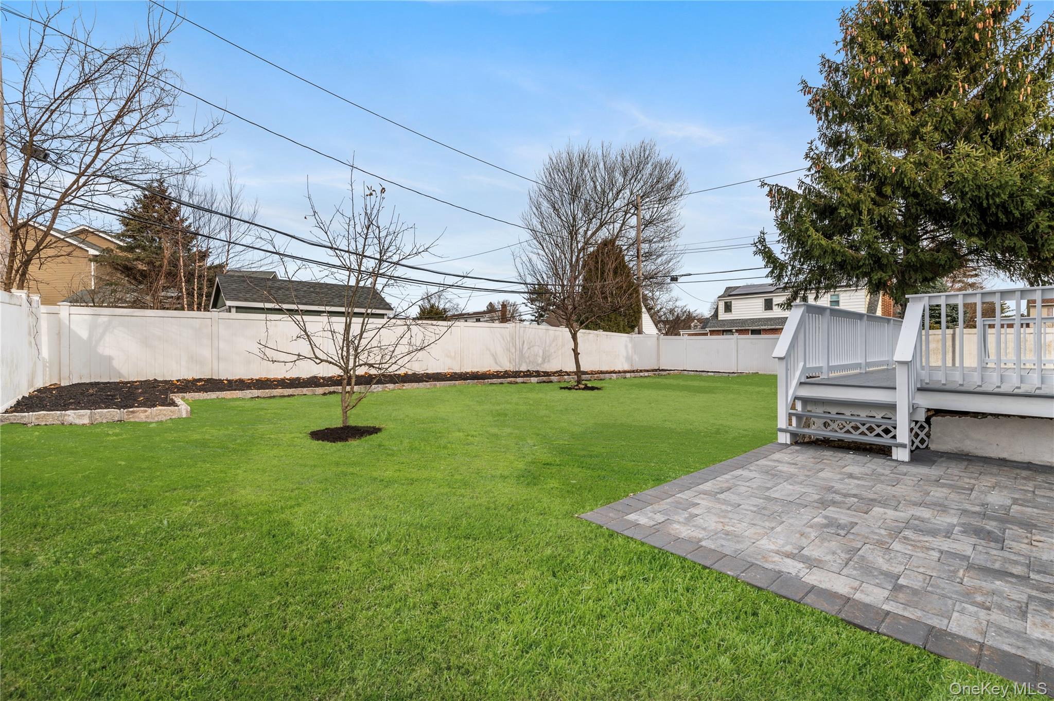 19 Hicks Avenue Syosset, NY 11791 - Photo 27 of 30 a view of backyard with wooden fence