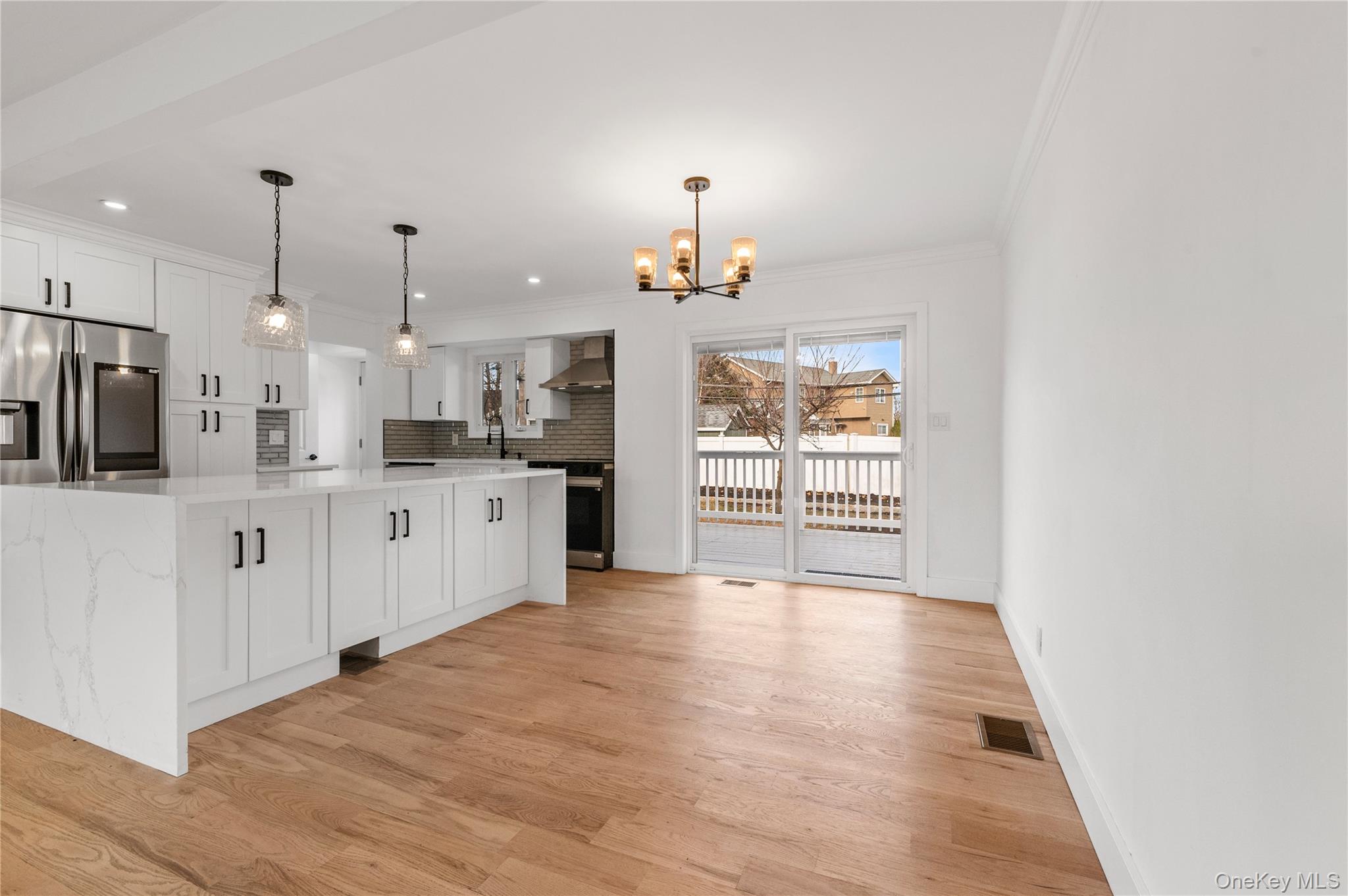 19 Hicks Avenue Syosset, NY 11791 - Photo 6 of 30 a large kitchen with kitchen island a sink stainless steel appliances and cabinets