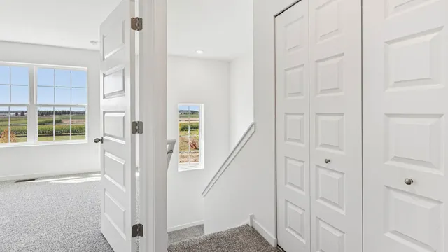 a view of an entryway with white walls and door