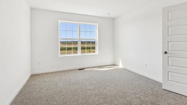 an empty room with closet and a bathroom