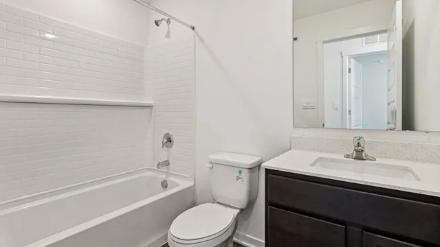 a bathroom with a sink toilet and vanity