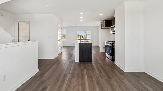 a view of a kitchen with wooden floor and a refrigerator